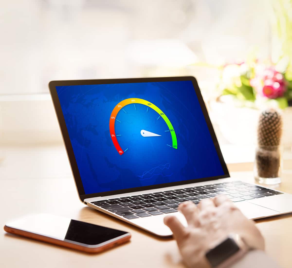 A man looking at his laptop, running a speed test