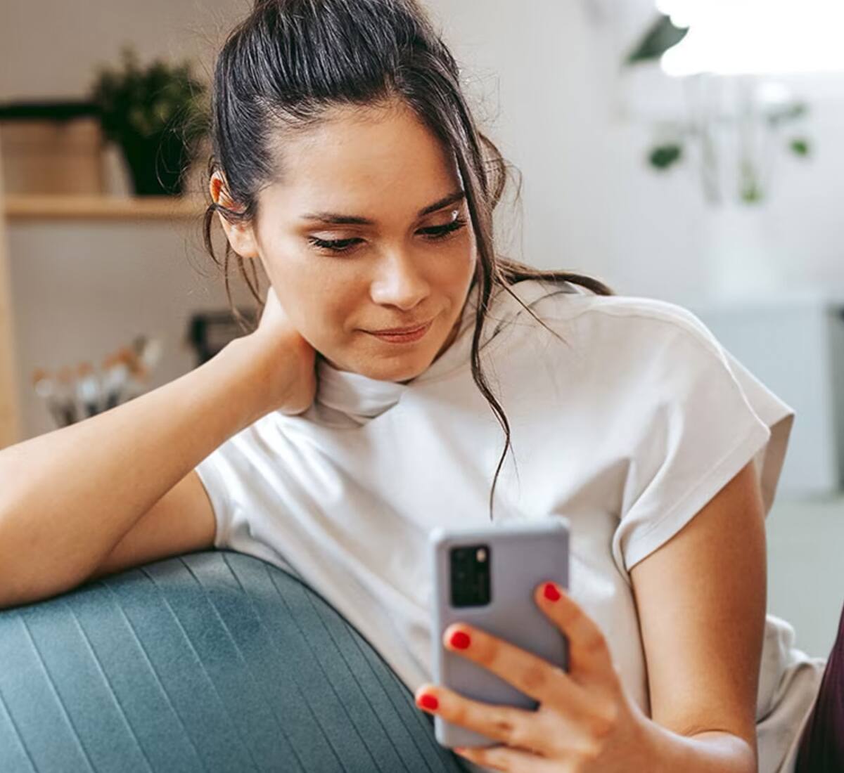 Woman sitting with phone using her wifi extender