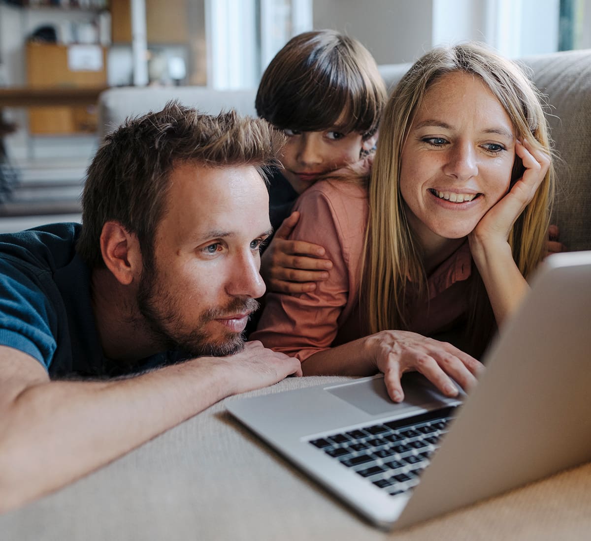 family looking at laptop