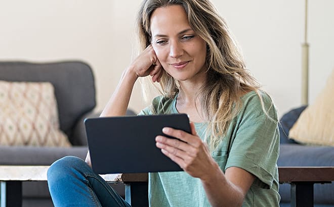 A Woman looking at her tab