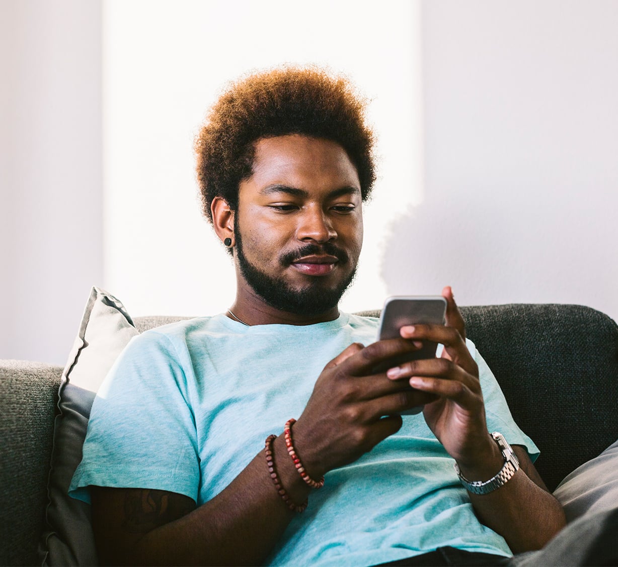 a man looking at phone and smiling