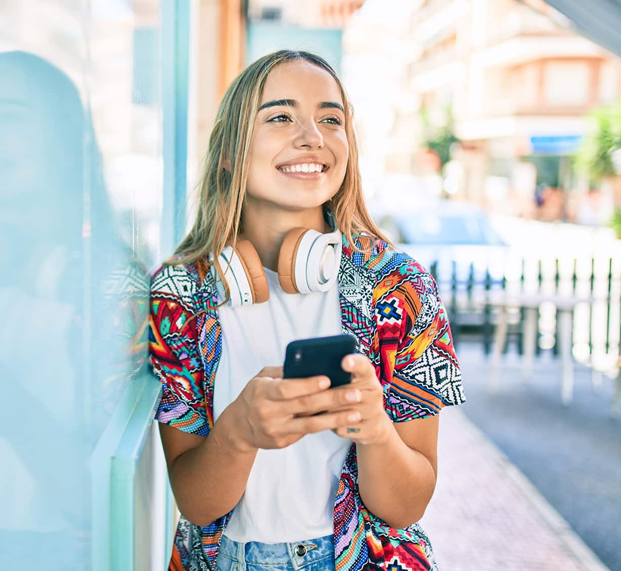 A girl looking elsewhere whilst holding the phone