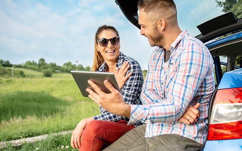 A boy and girl looking at tablet